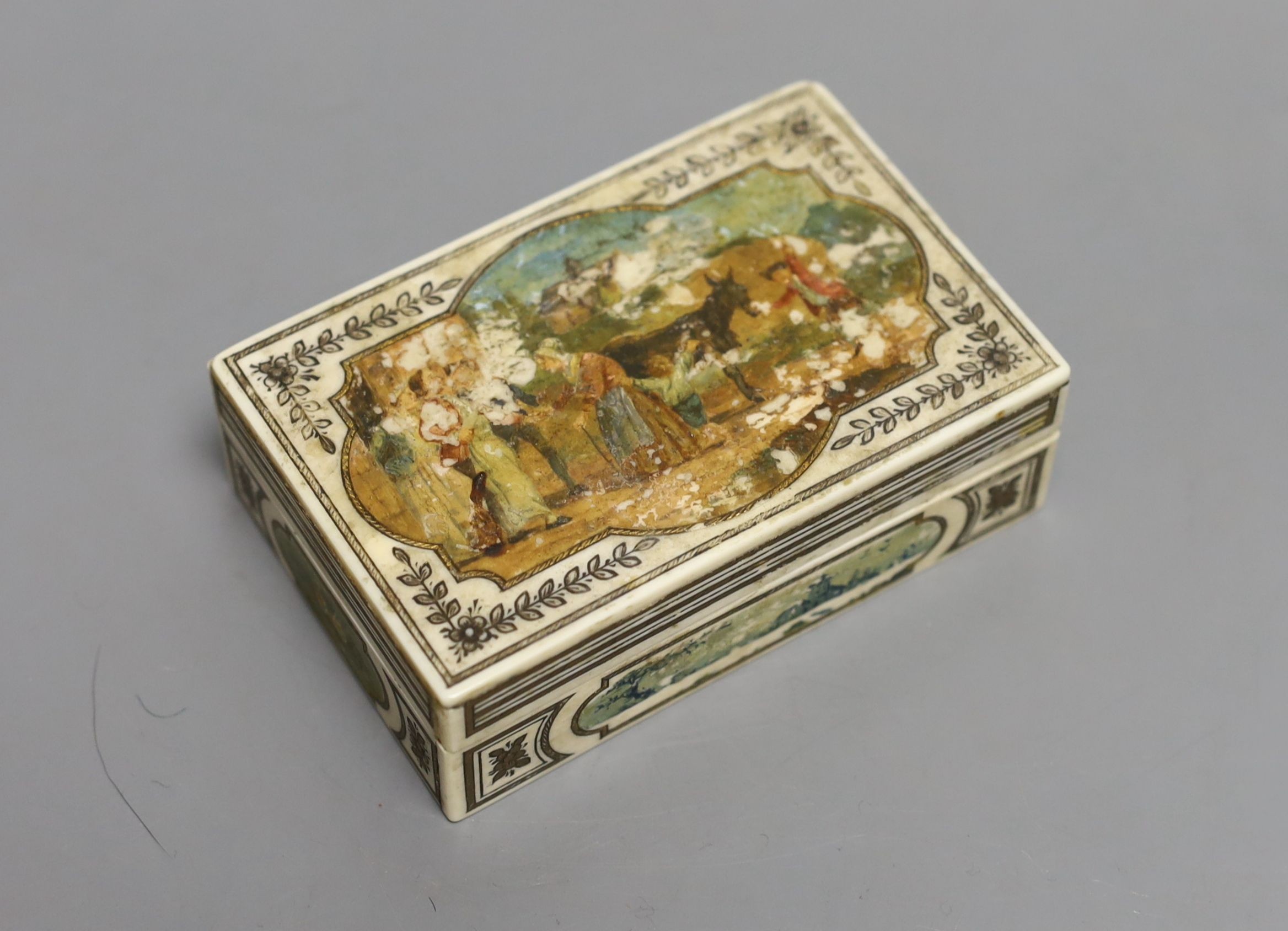 A 19th century Continental painted ivory box, mask to cap - 10cm long, 3.5cm tall